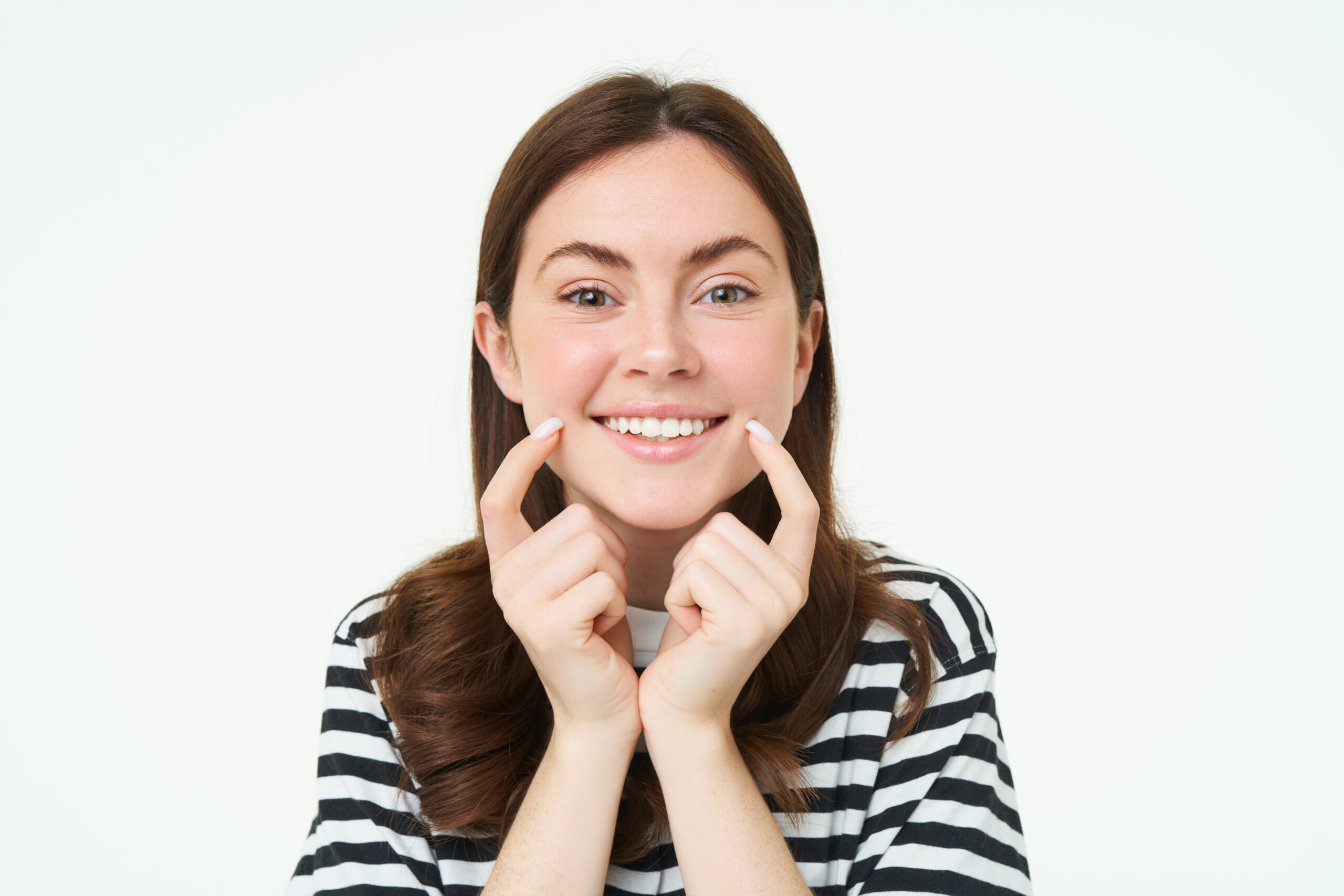 Beauty and women concept. Young smiling woman, showing her cute dimples on face and looking happy, positive emotion, beautiful face without blemishes, standing over white background