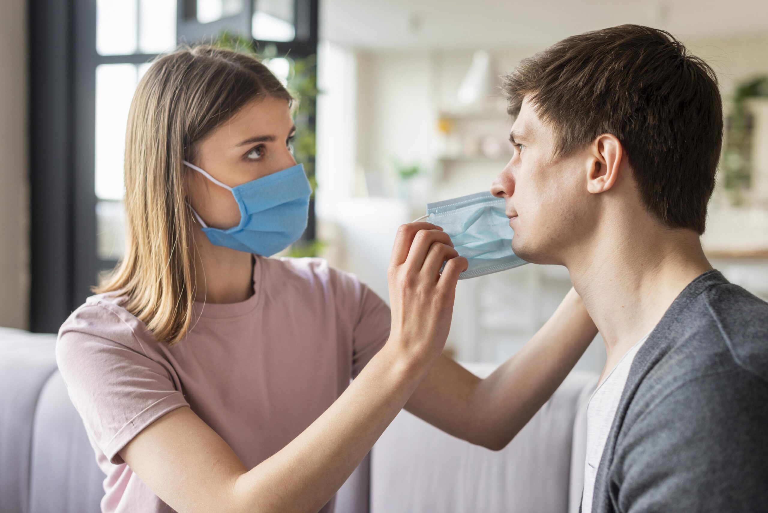 front-view-couple-using-medical-mask